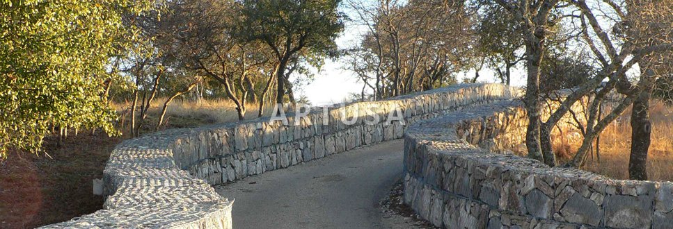 Stepped gabion retaining walls along a road